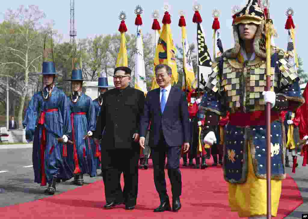 North Korean leader Kim Jong Un, left, and South Korean President Moon Jae-in walk together at the border village of Panmunjom in the Demilitarized Zone, April 27, 2018.