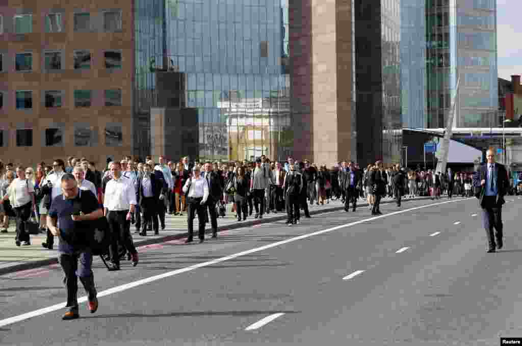 Commuters accross London Bridge after is was reopened following an attack which left seven people dead and dozens of injured in central London, June 5, 2017.