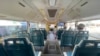 Few commuters ride on a mostly empty bus in Yangon.