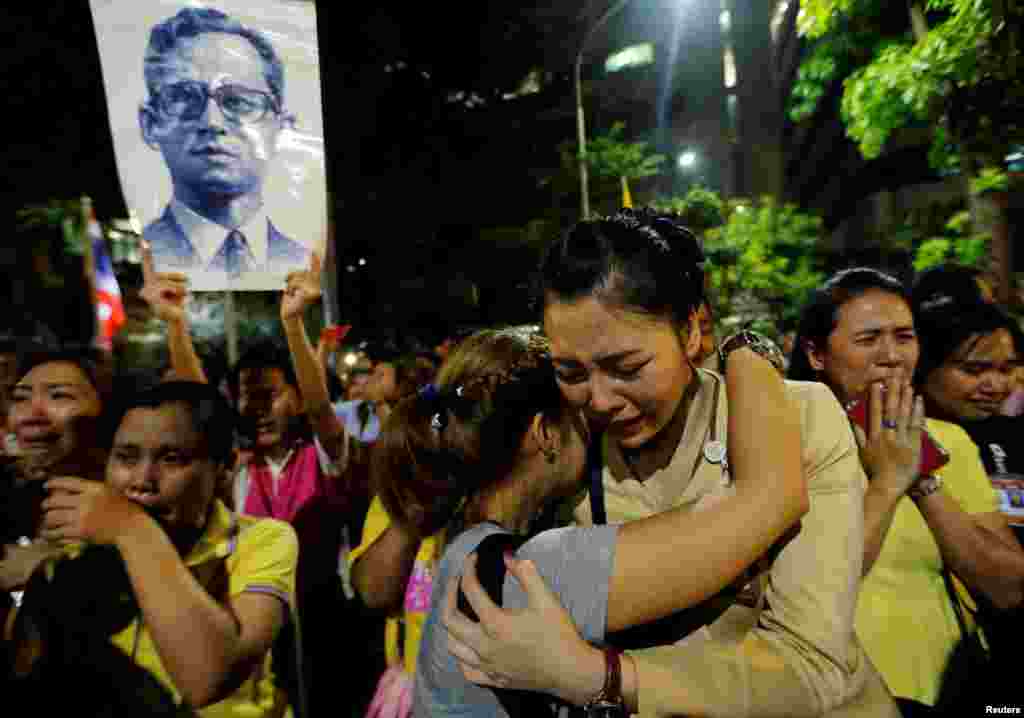 Well-wishers hug as they weep outside Thailand's King Bhumibol Adulyadej at the Siriraj hospital where he was residing in Bangkok, Thailand.