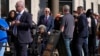 President Joe Biden helps a voter in a wheelchair in line at a polling station before casting his early-voting ballot for the 2024 general elections, New Castle, Delaware, Oct. 28, 2024.