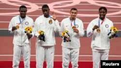 Gold medalist in the men's 4x400m relay, from left, Rai Benjamin (USA), Bryce Deadmon (USA), Michael Norman (USA) and Michael Cherry (USA) during the Tokyo 2020 Summer Olympic Games at Olympic Stadium. 