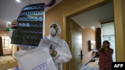 This photo taken on February 3, 2020 shows a doctor looking at a lung CT image while making his rounds at a ward of a quarantine zone in Wuhan, the epicentre of the new coronavirus outbreak, in China's central Hubei province. - The number of total infecti