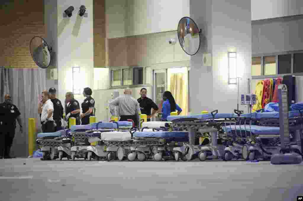 Emergency personnel wait with stretchers at the emergency entrance to Orlando Regional Medical Center hospital for the arrival of patients from the scene of a fatal shooting at Pulse Orlando nightclub in Orlando, Florida, June 12, 2016. 