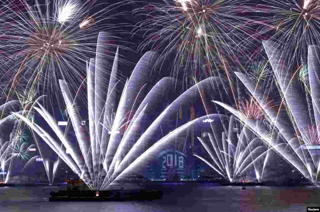 Fireworks explode over Victoria Harbour and Hong Kong Convention and Exhibition Centre to celebrate the New Year, Jan. 1, 2018.