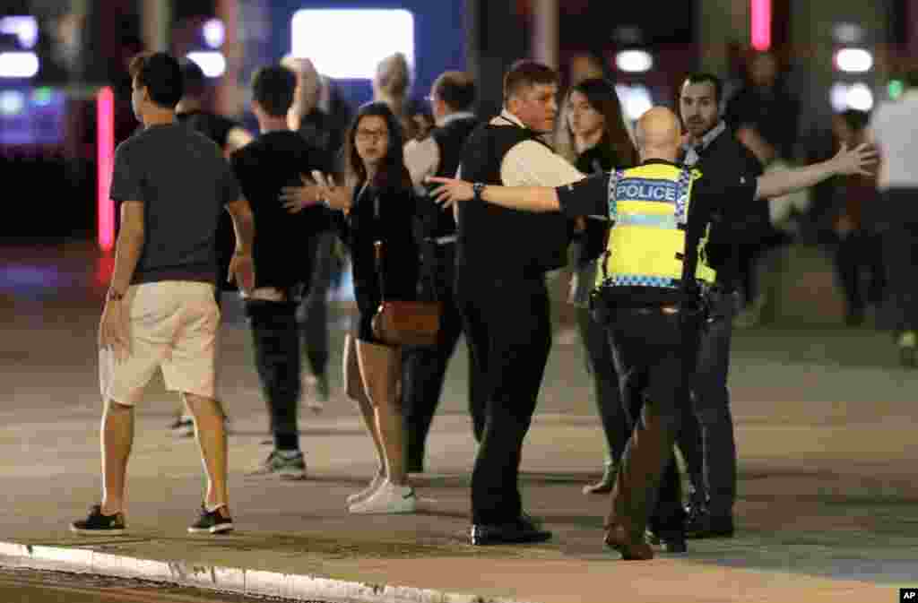 A police officer clears people away from the area near London Bridge after an incident in central London, June 3, 2017.