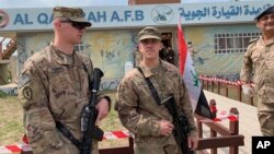 U.S. soldiers stand guard during the hand over ceremony of Qayyarah Airfield, Iraqi Security Forces, in the south of Mosul, Iraq early Friday, March 27, 2020. Iraq's military on Thursday said at least two rockets hit inside Baghdad's heavily…