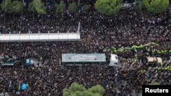 Mourners attend a burial ceremony of the late Iran's President Ebrahim Raisi in Mashhad