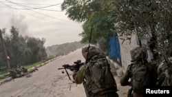 Israeli soldiers operate in a location given as Khan Younis