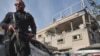 An Israeli policeman stands guard in front of a damaged building following a rocket attack from southern Lebanon that targeted the central Israeli-Arab city of Tira, on November 2, 2024, amid the ongoing war between Israel and Hezbollah. (Photo by JACK GUEZ / AFP) နိုဝင်ဘာ ၂ ရက်က လက်ဘနွန်တောင်ပိုင်းက ပစ်လွှတ်လိုက်တဲ့ ဒုံးကျည်တွေ ကျရောက်ခဲ့တဲ့ အစ္စရေး အလယ်ပိုင်း တီရာမြို့က ပျက်စီးသွားတဲ့ အဆောက်အအုံ