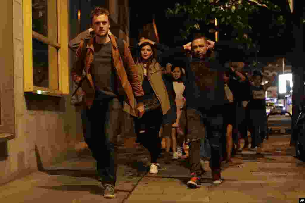 People leave from inside a police cordon after an attack in London, June 4, 2017. Armed British police rushed to London Bridge late Saturday after reports of a vehicle running down pedestrians and stabbings nearby.