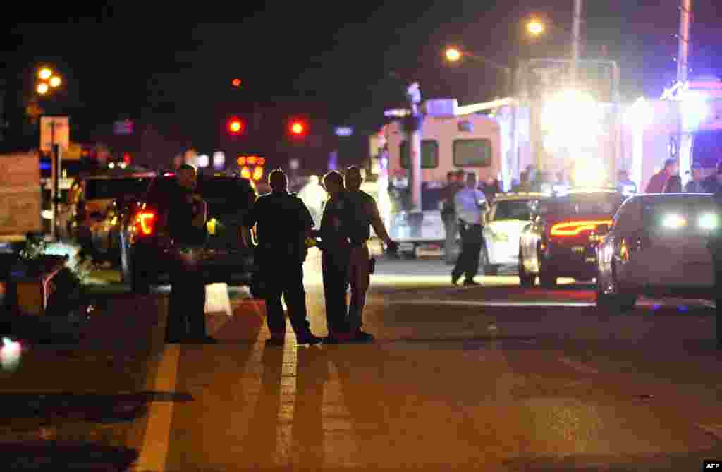 Police vehicles block the road to Marjory Stoneman Douglas High School in Parkland, following a shooting that killed 17 people in Parkland, Florida, Feb. 14, 2018. A former student armed with an AR-15 rifle opened fire at the high school, killing at least 17 people, officials said.