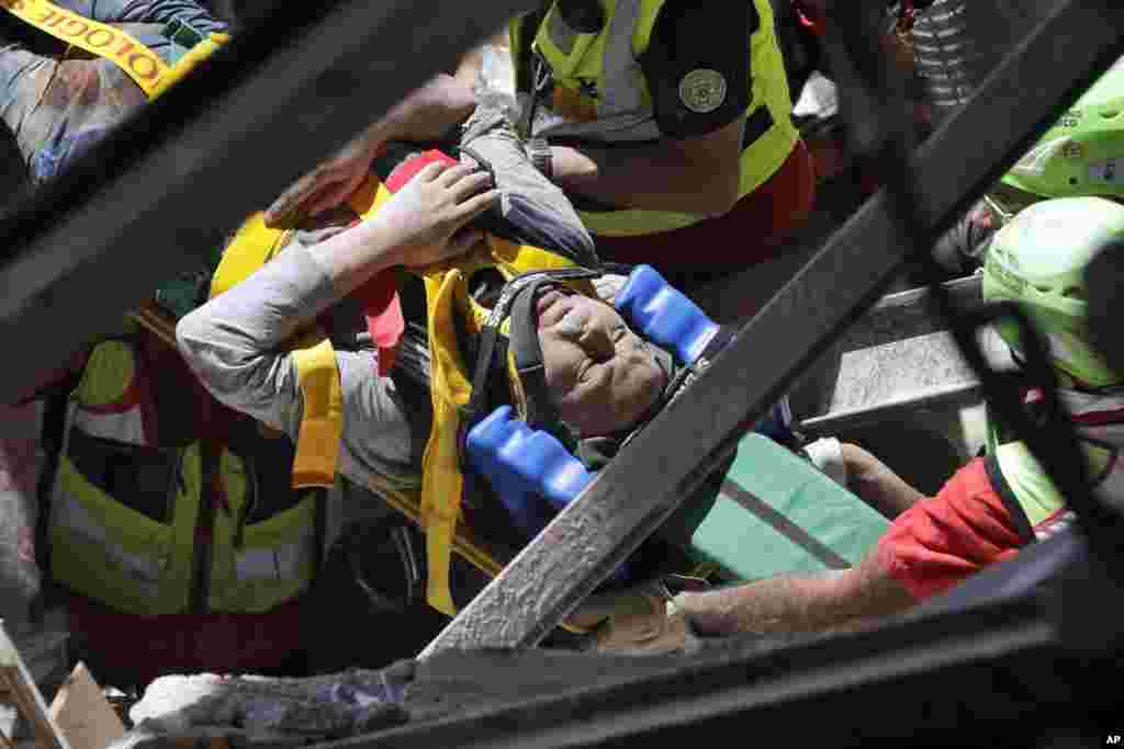 A man is rescued from the rubble of a building after an earthquake, in Accumoli, central Italy, Aug. 24, 2016.&nbsp; Rescue crews race to dig survivors out of the rubble, but the toll was expected to rise as crews reached homes in more remote hamlets.