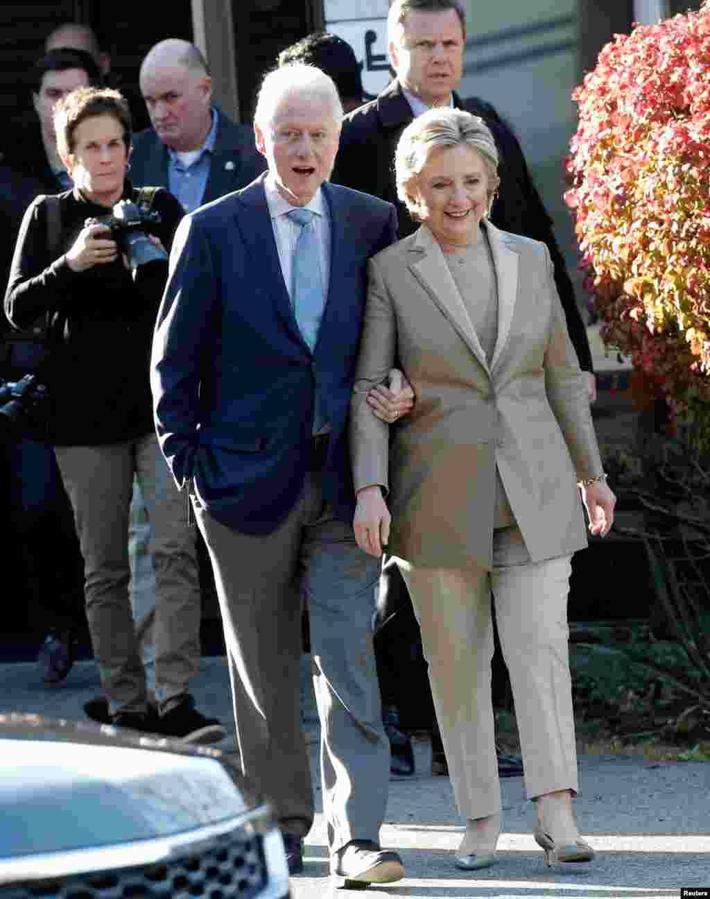 Hillary Clinton and her husband former U.S. president Bill Clinton depart after voting