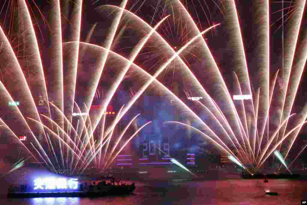 Fireworks explode over the Victoria Harbor during New Year's Eve to celebrate the start of year 2019 in Hong Kong, Jan. 1, 2019. 