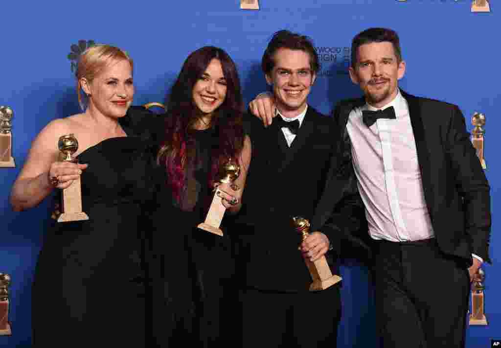 Patricia Arquette, from left, Lorelei Linklater, Ellar Coltrane, and Ethan Hawke pose in the press room with the award for best motion picture - drama for “Boyhood” at the 72nd annual Golden Globe Awards at the Beverly Hilton Hotel on Sunday, Jan. 11, 201