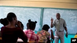 Students listen to school Director Jean Marc Charles at the Lycée school, which reopened about a week earlier than other schools in Petion-Ville, Haiti, Nov. 28, 2019. 