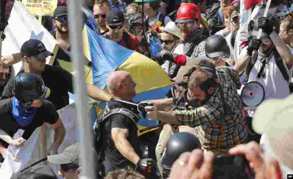 Alt Right demonstrators class with counter demonstrators at the entrance to Lee Park in Charlottesville, Aug. 12, 2017.