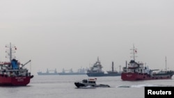 FILE PHOTO: Commercial vessels including vessels which are part of Black Sea grain deal wait to pass the Bosphorus strait off the shores of Yenikapi in Istanbul