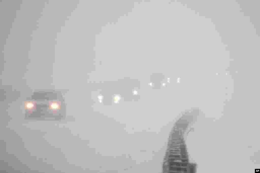 Vehicles commute southbound on the Garden State Parkway in whiteout conditions during a snowstorm in Eatontown, N.J., Jan. 4, 2018.