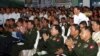 Senior General Min Aung Hlaing of Myanmar Armed Forces, centre front row, enjoys a performance as he visits a trade exhibition organized by the Union of Myanmar Economic Holding Limited (UMEHL) known as U Paing at Tatmataw Exhibition hall Friday, Dec. 20, 2013, in Yangon, Myanmar