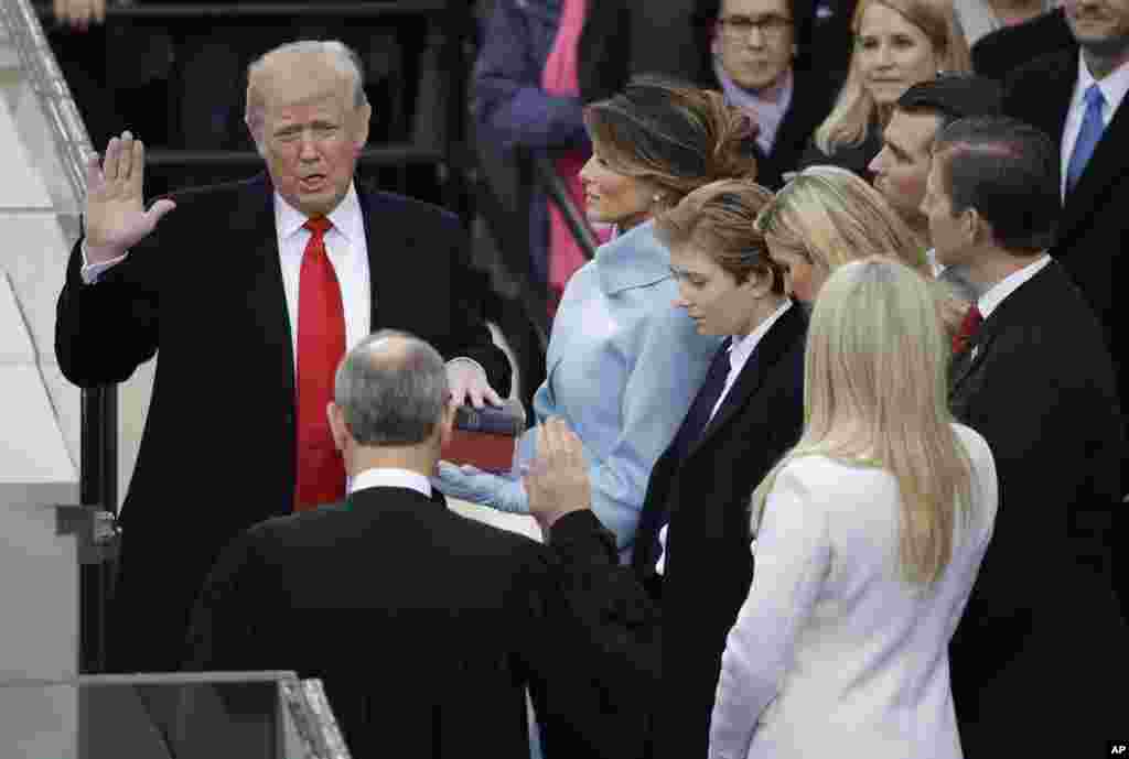 Donald Trump is sworn in as the 45th president of the United States by Chief Justice John Roberts as Melania Trump looks on during the 58th Presidential Inauguration at the U.S. Capitol in Washington, Jan. 20, 2017. 