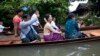  Myanmar opposition leader Aung San Suu Kyi, center, rides a boat on her way to a monastery where flood victims are sheltered, Monday, Aug. 3, 2015, in Bago, 80 kilometers (50 miles) northeast of Yangon, Myanmar. A report issued Saturday by the U.N. Offic