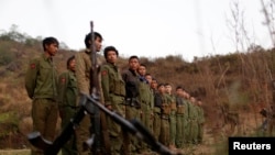 Rebel soldiers of Myanmar National Democratic Alliance Army (MNDAA) gather at a military base in Kokang region, March 11, 2015. 