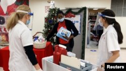 Walgreens Pharmacists prepare Pfizer-BioNTech coronavirus vaccines at Crown Heights Center for Nursing and Rehabilitation, a nursing home facility in Brooklyn, New York, Dec. 22, 2020.