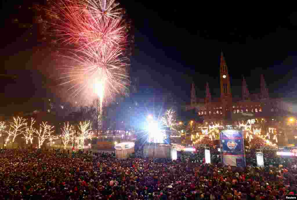 Fireworks explode over Vienna's city hall during New Year's celebrations in Vienna, Austria, Jan. 1, 2019. 