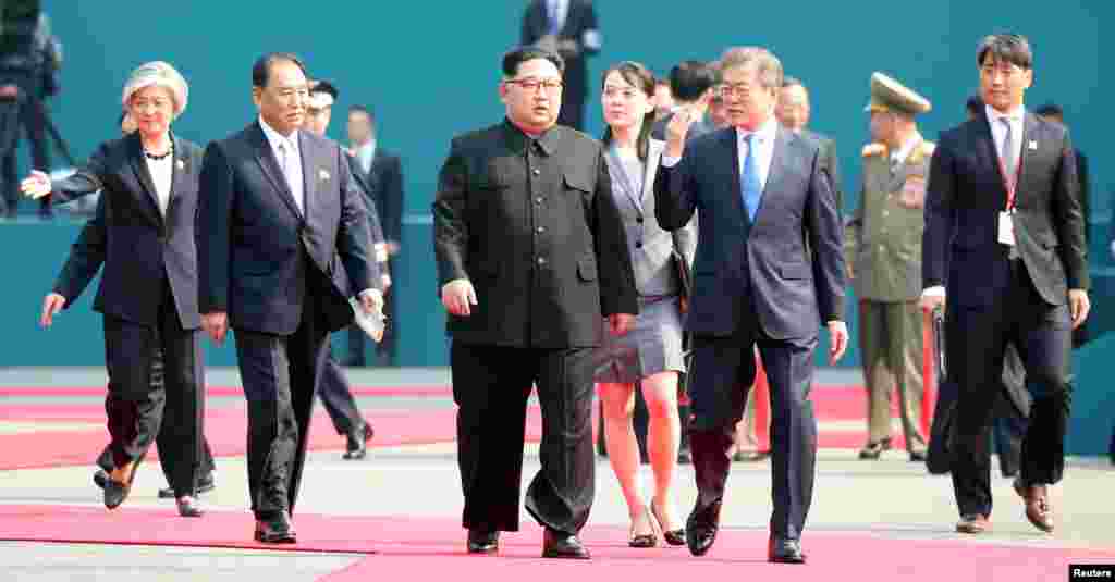 South Korean President Moon Jae-in and North Korean leader Kim Jong Un arrive at the Peace House in the truce village of Panmunjom inside the demilitarized zone separating the two Koreas, South Korea, April 27, 2018.