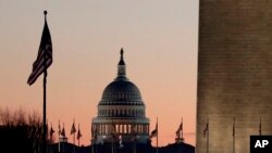 FILE - The U.S. Capitol building, center, and part of the Washington Monument, right, are seen in Washington, Dec. 18, 2019.