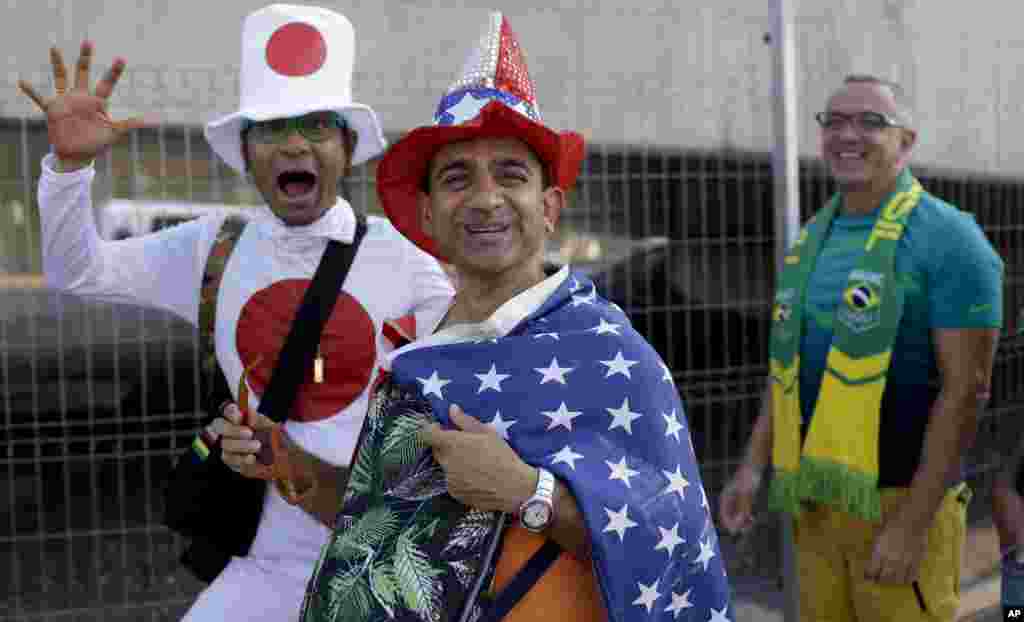 Fans from Japan, United States and Brazil, from right to left, walk toward the Maracana Stadium ahead of the opening ceremony for the 2016 Summer Olympics in Rio de Janeiro, Brazil, Aug. 5, 2016.