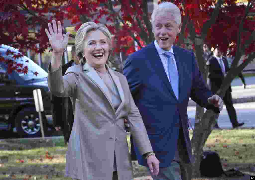 Democratic presidential candidate Hillary Clinton, and her husband former President Bill Clinton, greet supporters after voting in Chappaqua, N.Y., Nov. 8, 2016.