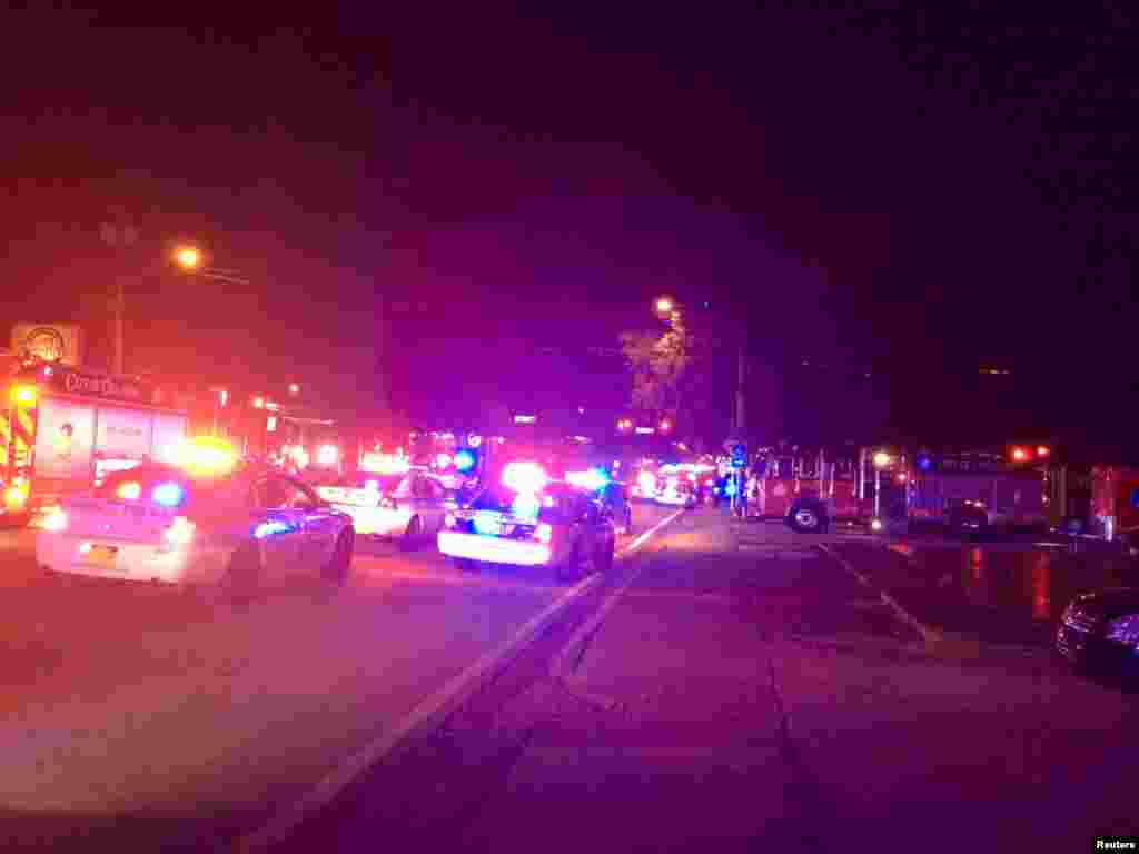 Police cars and fire trucks are seen outside the Pulse night club where police said a suspected gunman left multiple people dead and injured in Orlando, Florida, June 12, 2016. 