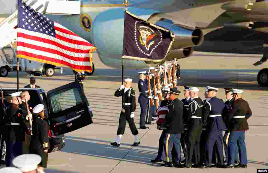 A military honor guard carries the casket of former U.S. President George H.W. Bush as it arrives at Joint Base Andrews in Maryland, Dec. 3, 2018.