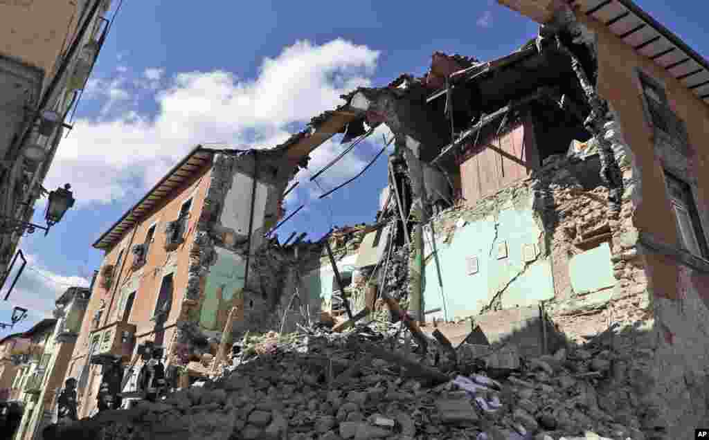 Firefighters search amid the rubbles of a collapsed building in Amatrice, Italy, Aug. 24, 2016, where a magnitude 6 quake struck at 3:36 a.m. (0136 GMT).