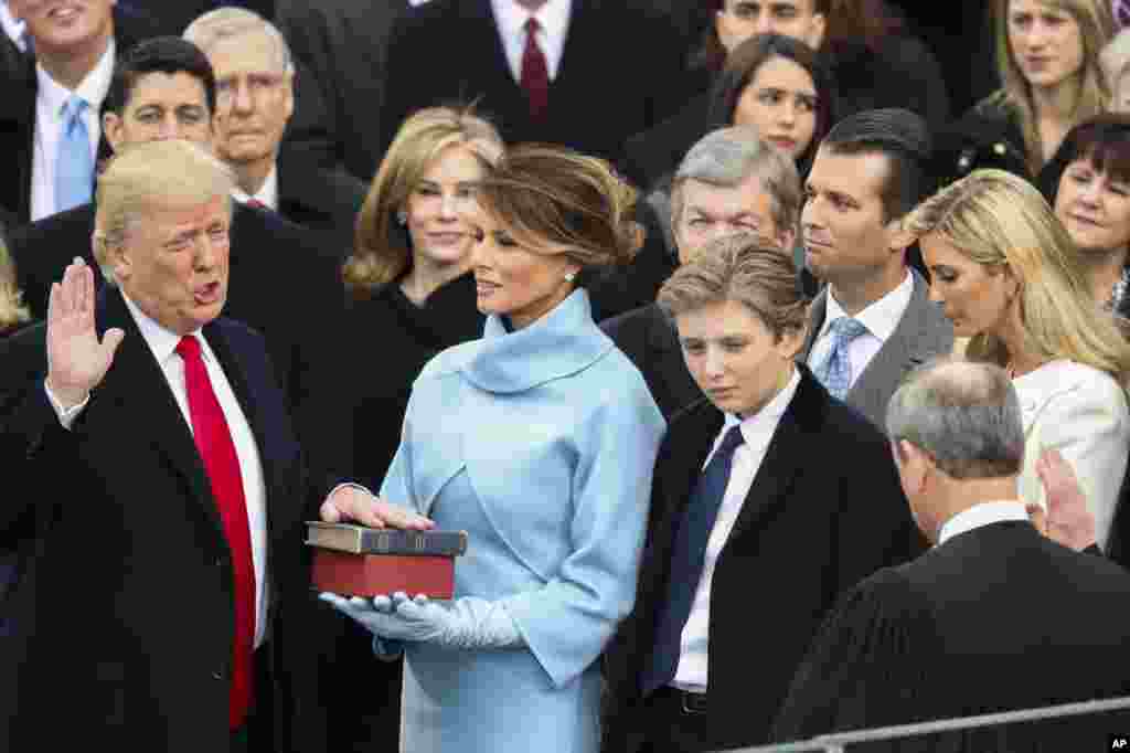 Donald Trump is sworn in as the 45th president of the United States by Chief Justice John Roberts as Melania Trump looks on during the 58th Presidential Inauguration at the U.S. Capitol in Washington, Jan. 20, 2017. 