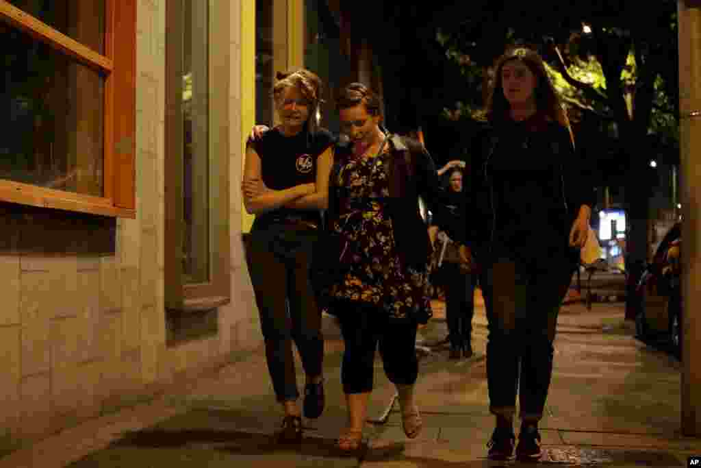 People walk away about 10 minutes after midnight from inside a police cordon after an attack in London, June 4, 2017.