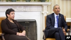 Attorney General Loretta Lynch listens as President Barack Obama speaks in the Oval Office of the White House, Jan. 4, 2016.