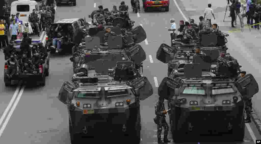 Indonesian soldiers man armored vehicles as they guard near the site where an attack occurred in Jakarta.