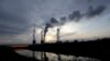 Smoke rises from chimneys of the Turow power plant located by the Turow lignite coal mine near the town of Bogatynia, Poland.