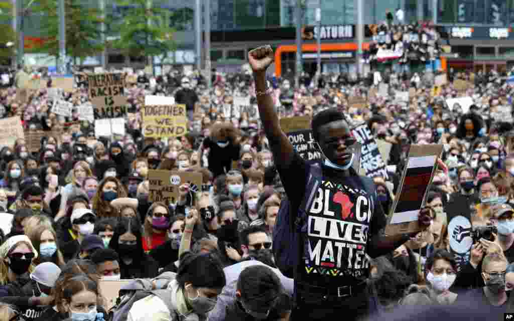 A man raises his fist as people gather in Berlin, Germany, Saturday, June 6, 2020, to protest against the recent killing of George Floyd by police officers in Minneapolis, USA, that has led to protests in many countries and across the US. A US…