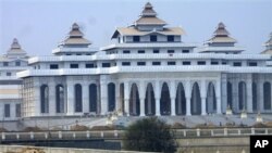 In this photo taken March 27, 2010, daily waged labors work at new parliament building in Nay Pyi Taw, Myanmar. Freedom of speech for members of parliament in military-controlled Myanmar will be restricted under laws that dictate the functioning of the ne