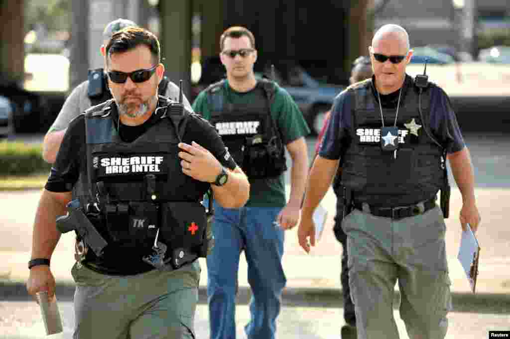 Officers arrive at the Orlando Police Headquarters during the investigation of a shooting at the Pulse nightclub, where people were killed by a gunman, in Orlando, Florida, June 12, 2016.