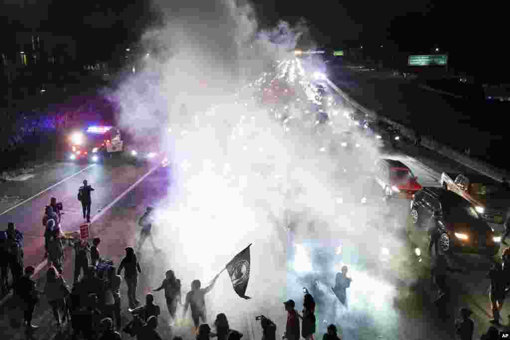 Protesters against racism block traffic on both directions of Interstate 580 in Oakland, California, Aug. 12, 2017.