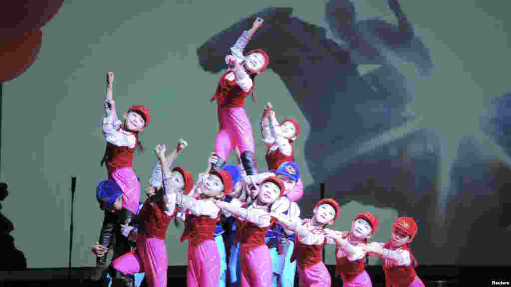 In a photo released by North Korea's Korean Central News Agency, schoolchildren perform "We Are the Happiest in the World" at the Central Youth Hall for New Year's Eve festivities in Pyongyang, Dec. 31, 2014.