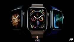 Apple CEO Tim Cook discusses the new Apple Watch 4 at the Steve Jobs Theater during an event to announce new products Wednesday, Sept. 12, 2018, in Cupertino, Calif. (AP Photo/Marcio Jose Sanchez)