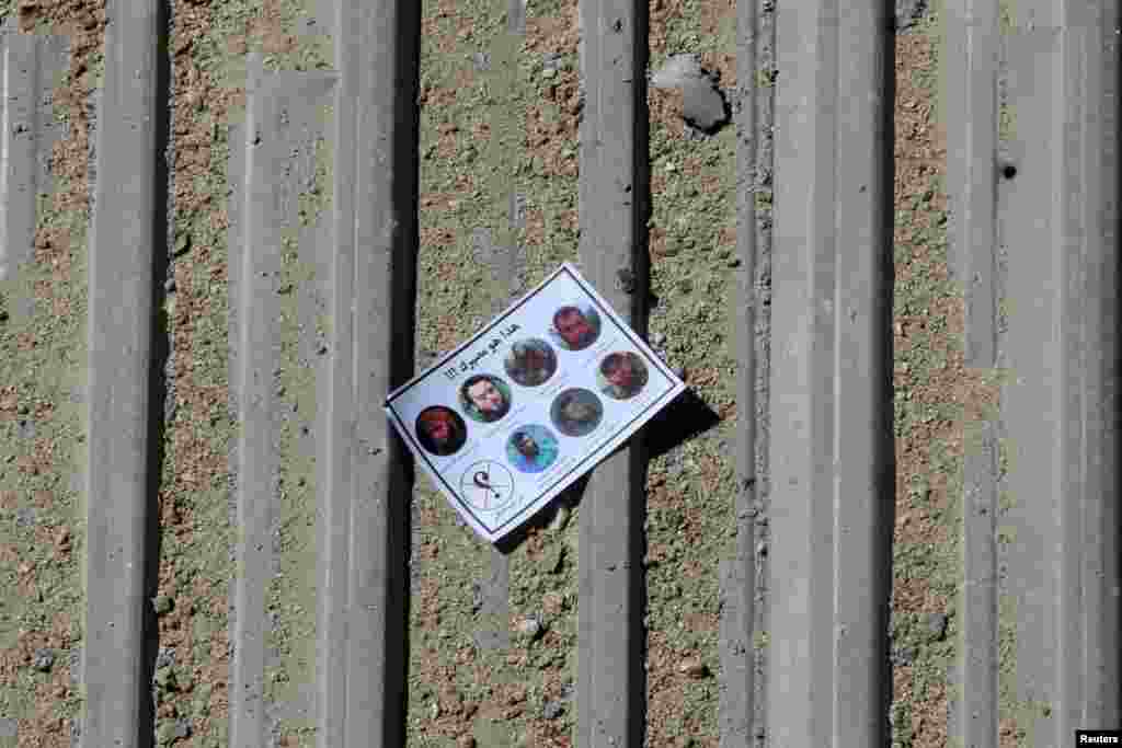 One of the warning leaflets dropped by the Syrian army is seen in the rebel held Tariq al-Bab neighbourhood of Aleppo, Sept. 25, 2016.