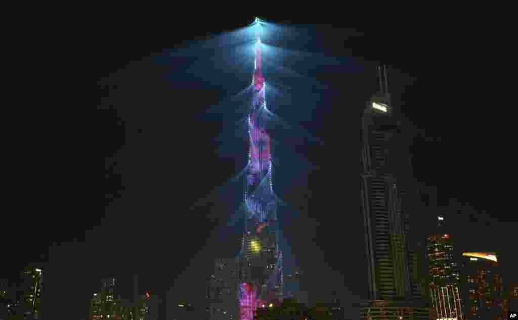 A LED light show illuminates the Burj Khalifa, the world's tallest building, to celebrate the New Year in Dubai, United Arab Emirates, Monday, Jan. 1, 2018.